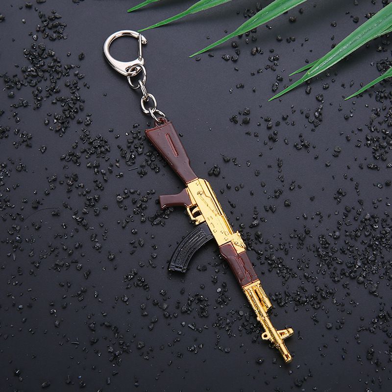 Key chain PUBG helmet pan weapon model pendant peripheral street stall key chain small gifts. 